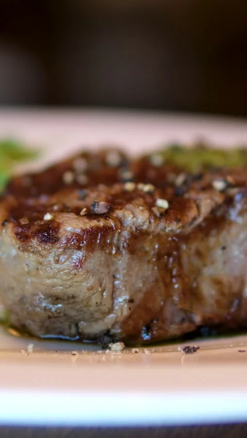 Filet Mignon Close up of beef steak with microgreen and salt rotating on black 스톡 동영상 293971949