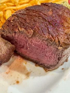 Filet mignon medium-rare steak with french fries 库存照片