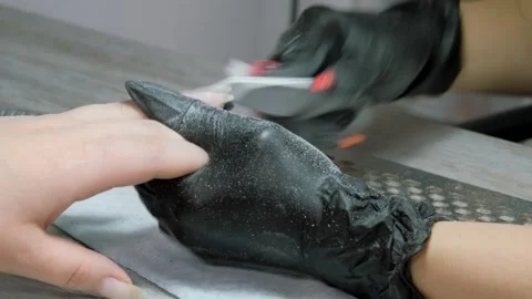 Filing the nail of the hand with a nail file. Hardware combined manicure Stock-Footage 287945883