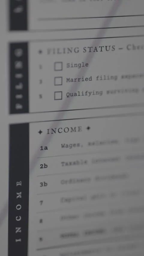 Filing Status and Income sections of IRS Form 1040 with applied stamp labeled Stock Footage 333414726