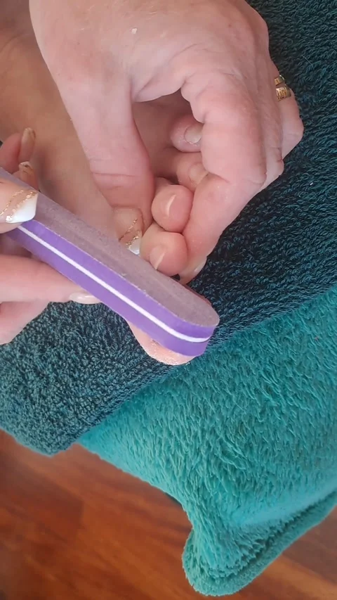 Filing toenails during a home pedicure. Stock Footage 342322525