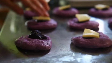 Filipino bread called Ube cheese pandesal being prepared for baking. Stock Footage 331850377