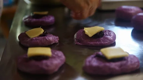 Filipino bread called Ube cheese pandesal being prepared for baking. Stock Footage 331850394