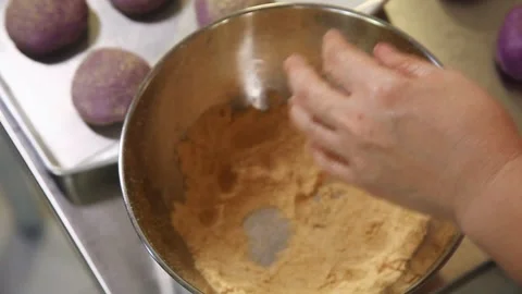 Filipino bread called Ube cheese pandesal being prepared for baking. Stock Footage 331850396