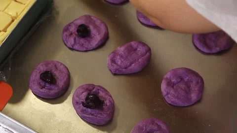 Filipino bread called Ube cheese pandesal being prepared for baking. Stock Footage 331850397