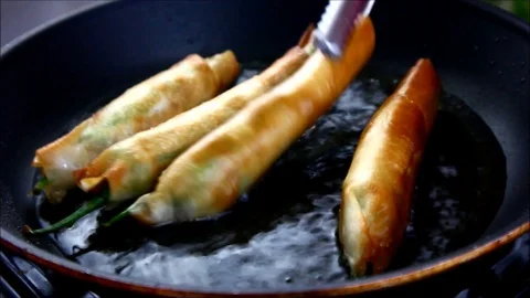 Filipino dish called dynamite being fried in a pan Video stock 116011479