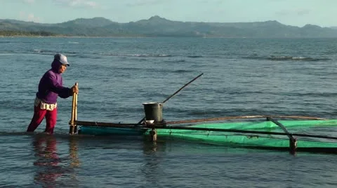 Filipino woman catching Milkfish fry in ... | Stock Video | Pond5