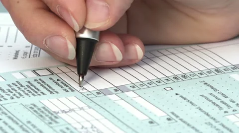 Fill out your US tax return: tax form 1040, the young woman's hand writing Stock Footage