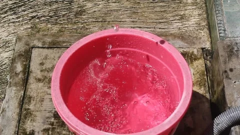 Fill water into a bucket Stock Footage 247902567