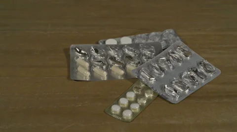 Filled and empty tablet packagings falling down Stock Footage 37934479