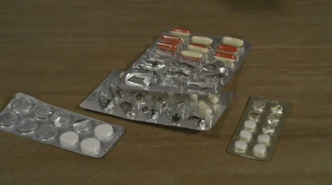 Filled and empty tablet packagings falling down Stock Footage 37934577