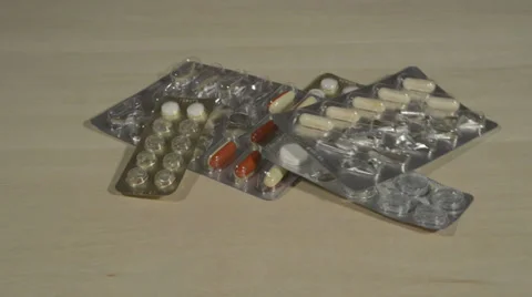 Filled and empty tablet packagings falling down Stock Footage 37934873