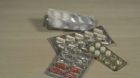 Filled and empty tablet packagings falling down Stock Footage 37934954