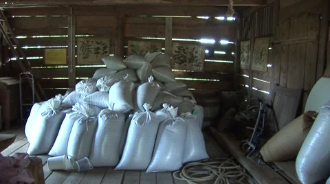 Filled bags of grain in barn Stock Footage 1070367