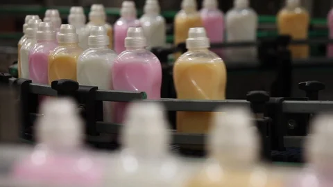 Filled bottle on conveyor belt, process, deep shallow focus Video stock 128317215