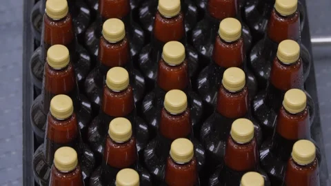 Filled bottles without labels go along the conveyor Stock Footage 240924178