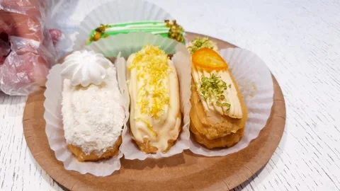 Filled eclairs. Multicolored eclairs, dessert, sweet pastries. Stock Footage 314132729