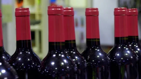 Filled red wine bottles on an automated coveyer belt in South Australia Stock Footage 131309364