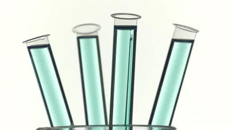 Filled test tubes with blue liquid on a turntable Video stock 64292613
