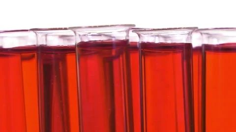 Filled test tubes with red liquid on a turntable Video stock 64287606