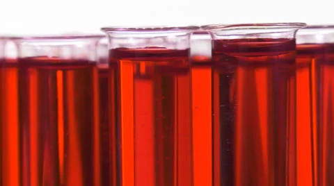 Filled test tubes with red liquid on a turntable Video stock 64287682