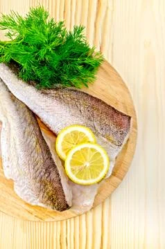 Fillet of codfish on a round plate with lemon Stock Photos