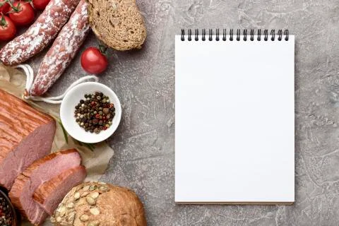 Fillet meat and salami with notebook Photo Stock Photos