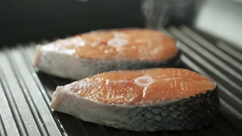Fillet of red fish is fried in a pan. Seafood. Salmon preparation. Stock Footage 150265909