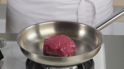 A fillet steak being flipped in a pan Stock Footage 24657039