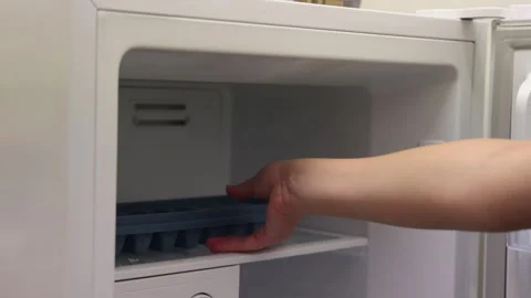 Filling and Retrieving Ice Tray from Freezer Stock Footage 287961749