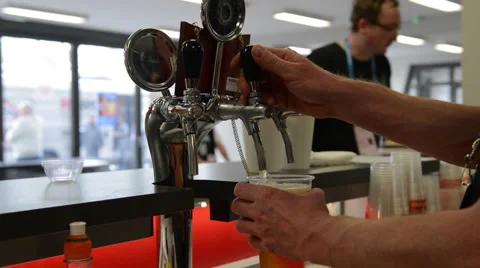 Filling Beer in a Plastic Cup in an Indoor Public Event Stock Footage 61769780