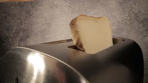Filling bread into a toaster - close-up shot Stock Footage 149883794