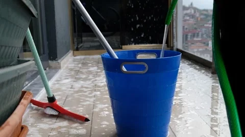 Filling a Bucket with Water Using a Hose and Dipping a Brush Stock Footage 274896588