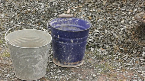 Filling buckets with broken stone Stock Footage 38936096
