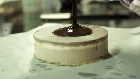Filling cake layers. Making Chocolate Layer Cake Video stock 71486488