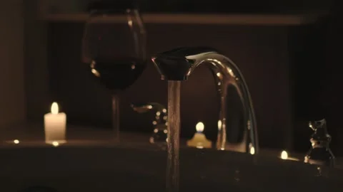 Filling up candlelight bath with red wine Stock Footage 277021676