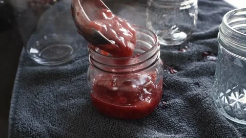 Filling canning jar with strawberries Stock Footage 241117099