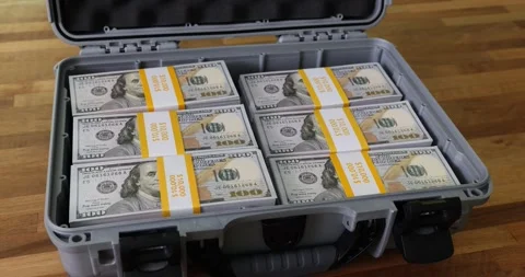 Filling case with dollars and yellow combination lock on top of pile of money Stock Footage 252446660