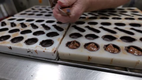 Filling Chocolate Molds With Second Layer Video stock 331115744