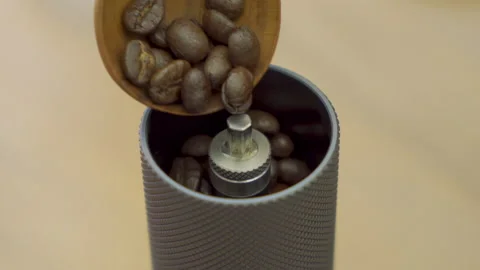 Filling the coffee grinder with coffee beans Video stock 148167010