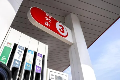 Filling column with pistols with different types of fuel at the gas station Stock Photos