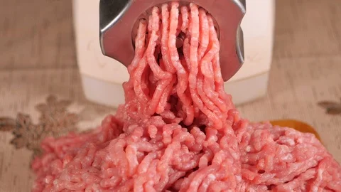 Filling comes out through a meat grinder sieve. Meat grinder close up. Video stock 122588384