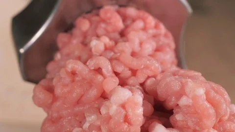 Filling comes out through a meat grinder sieve. Meat grinder close up. Pile of Stock Footage 125138280