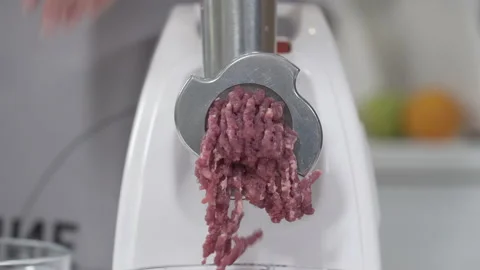 Filling comes out through raw meat grinder sieve. Grinder closeup. Electric 스톡 동영상 130195616