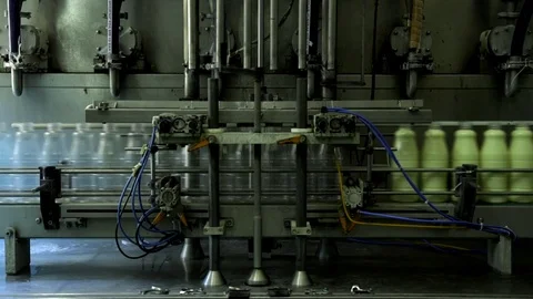 The filling of condensed milk in bottles Stock Footage 73835103