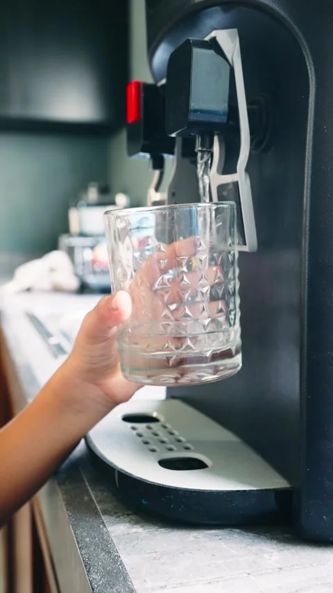 Filling a Cup with Drinking Water from the Water Dispenser Stock Footage 277222154
