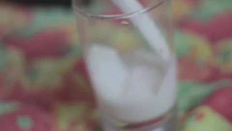 Filling a cup with fresh  white milk Stock Footage 79537207