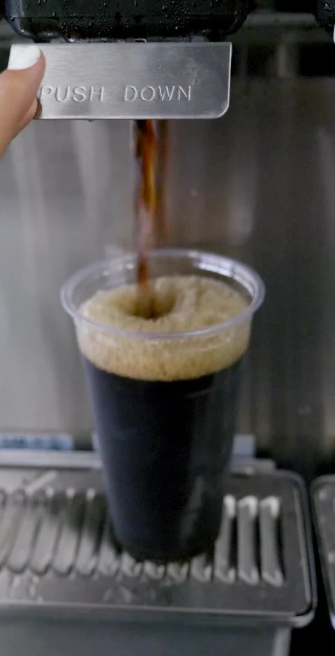 Filling Cup With Iced Coffee From Machine Vertical Video Stock Footage 138714302