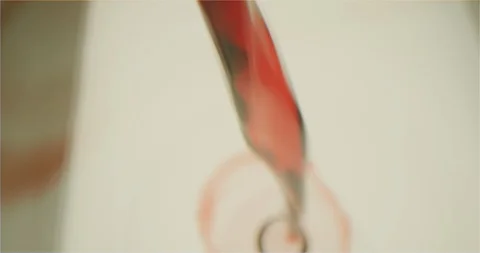 Filling up a cup with red wine macro shot Video stock 126259369