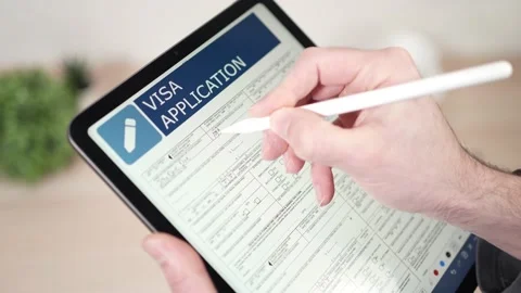 Filling a Digital Visa Application Document Online on a Tablet Stockbeeldmateriaal 234013417